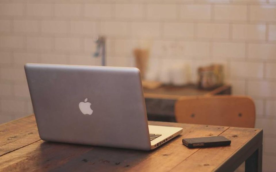 A clean desk with a laptop left open
